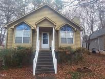 Tan house with white steps and landscaping at 316 Wilson Street, Graham, NC 27253