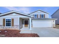 Two-story house with brown accents and stone detailing. Attached garage and manicured landscaping at 514 Kerriann Ln, Clayton, NC 27520