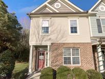 Two-story brick home with a charming front porch and well-manicured landscaping at 520 Matheson Pl, Cary, NC 27511