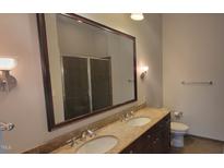 Modern bathroom with double vanity, large mirror, and shower at 618 N Boylan Ave # 1028, Raleigh, NC 27603