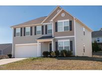 Two-story house with gray siding, white garage door, and landscaping at 1134 Aster Way, Burlington, NC 27215