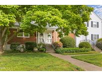 Charming brick townhouse with a welcoming front entrance and lush landscaping at 1621 Sutton Dr, Raleigh, NC 27605