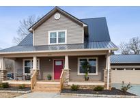 Two-story house with gray siding, a dark roof, and a red front door at 402 W Clay St, Mebane, NC 27302