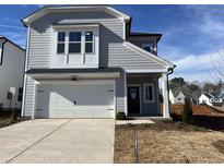 Charming two-story home with a white garage door and beautifully contrasting trim against a light gray exterior at 4321 Darius Ln # 23, Fuquay Varina, NC 27526
