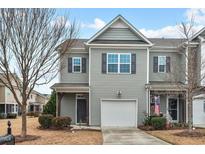 Gray two-story townhome with attached garage and small front yard at 1011 Skyler Ln, Durham, NC 27705