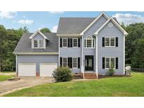 Two-story house with gray siding, black shutters, and a two-car garage at 102 Ridge Ln, Youngsville, NC 27596