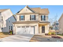 Two-story house with a two-car garage and landscaping at 2035 Seford Dr, Durham, NC 27703