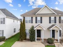 Tan two-story house with black shutters and a tree in the front at 2332 Turtle Point Dr, Raleigh, NC 27604