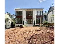 Modern two-story home with large windows and a brick facade, awaiting landscaping at 3315 Hampton Rd, Raleigh, NC 27607