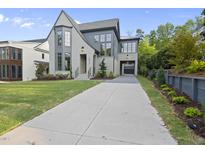 Stunning two-story home features a modern gray exterior, manicured lawn, and an inviting driveway at 3317 Hampton Rd, Raleigh, NC 27607