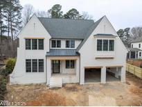 Two-story white brick home with a gray roof and attached two-car garage at 4005 Brevard Pl, Raleigh, NC 27609