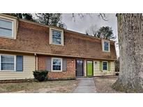 Brick front exterior of charming townhome with green door and walkway at 4703 Blue Bird Ct # I, Raleigh, NC 27606