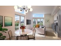 Open concept living room with dining area and city views at 507 Yancey St # 303, Durham, NC 27701