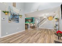 Spacious living room with vaulted ceiling, fireplace, and laminate flooring at 5849 Ricker Rd, Raleigh, NC 27610