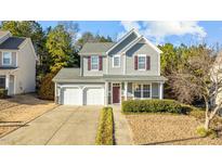 Two-story house with gray siding, two-car garage, and manicured lawn at 631 Virginia Water Dr, Rolesville, NC 27571