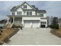 Beautiful two-story home featuring a spacious three-car garage and a welcoming front porch at 1229 Azalea Garden Cir, Raleigh, NC 27603