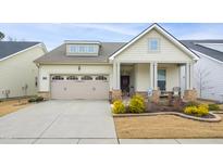 Charming one-story home with a three-car garage and landscaped front yard at 1318 Mascoma Dr, Apex, NC 27502
