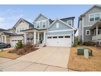 Two-story home with light blue siding, white trim, and a two-car garage at 215 Mindees Ln, Pittsboro, NC 27312