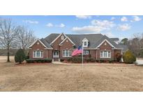 Brick home with large front yard and American flag at 255 Dupree Rd, Willow Springs, NC 27592