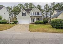 Two-story house with a gray exterior, attached garage, and well-maintained lawn at 3124 Gross Ave, Wake Forest, NC 27587