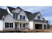 Charming two-story home featuring white siding, black shutters, and an attached two-car garage at 38 Hewitt Woods Dr, Clayton, NC 27527