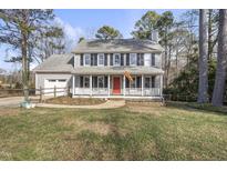 Two-story house with gray siding, red door, and attached garage at 4224 Sancroft Dr, Apex, NC 27539