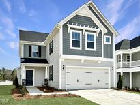 Charming two-story home with a two car garage, manicured lawn, and welcoming front entrance at 45 Nimble Way # 180, Clayton, NC 27520