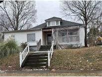 White single-story home with steps leading to a covered porch at 614 Tucker St, Burlington, NC 27215