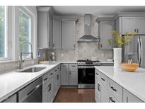 Modern kitchen features stainless steel appliances, gray cabinetry and white countertops at 727 Martin Luther King Jr Blvd Blvd, Raleigh, NC 27601