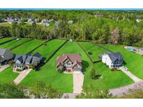 Aerial view of two story house with large backyard and neighborhood at 7945 Parker Mill Trail, Fuquay Varina, NC 27526
