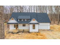 White farmhouse exterior with gray roof and stone accents at 94 Foust Rd, Mebane, NC 27302