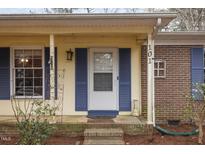 Inviting front porch with blue shutters and brick steps at 101 Monterey Ln, Durham, NC 27713
