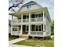 Charming two-story home with a double front porch, white railings, and a well-manicured lawn at 1300 Broad St # A, Durham, NC 27705