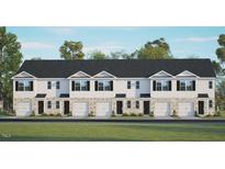 Three-story townhome building with attached garages and lawn at 313 Cherry Laurel Dr, Sanford, NC 27332