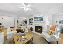 Bright living room features a fireplace, built-in shelving, and comfortable seating at 3701 Baron Cooper Pass # 205, Raleigh, NC 27612