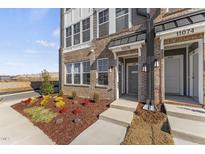 Brick front exterior of modern townhome with landscaping at 414 Gaston Park Ln # 100, Wake Forest, NC 27587