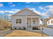 Charming craftsman style house with a front porch and landscaped lawn at 407 Sixth St, Wake Forest, NC 27587