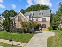 Two-story house with stone accents and landscaped yard at 4913 Great Meadows Ct, Raleigh, NC 27609