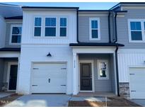 New construction townhome with gray siding and white trim at 5002 Cambrey Dr # 2, Durham, NC 27703