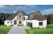 Beautiful two-story home showcasing stone and siding accents, complemented by a three-car garage and lush landscaping at 64 Barn Owl, Pittsboro, NC 27312