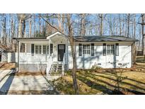 Charming ranch home with white exterior, front porch, and landscaped yard at 1014 Holden Rd Rd, Youngsville, NC 27596