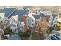 Aerial view of a charming gray and brick townhome community at 1061 Wirewood Dr # 102, Raleigh, NC 27605