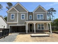 Newly constructed two-story home showcasing a covered entrance and attached two-car garage at 1105 Opal Ln # 70, Durham, NC 27705