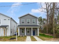 Charming two-story home featuring a covered front porch and blue front door at 115 S Plum St, Durham, NC 27703