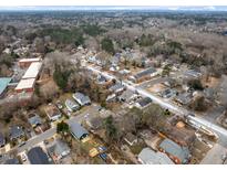 An aerial view showcasing the neighborhood's layout and surrounding tree cover during the winter season at 1501 S Roxboro St, Durham, NC 27701