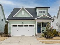 Charming craftsman style home with a two-car garage and landscaped front yard at 1908 Cypress Cove Dr, Wendell, NC 27591