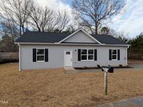Charming single story home with light gray siding, black shutters, and a well-maintained lawn at 420 E Cedar Ave, Wake Forest, NC 27587