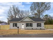 Charming single-story home with grey siding, black shutters, and a well-manicured front yard at 420 E Cedar Ave, Wake Forest, NC 27587