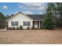 Ranch style home with stone accents and mature landscaping at 4304 Maggie Ct, Liberty, NC 27298