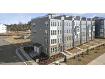 Contemporary townhome with brick and gray siding, offering ample windows and a landscaped front yard at 600 Market Grove Dr # 200, Wake Forest, NC 27587